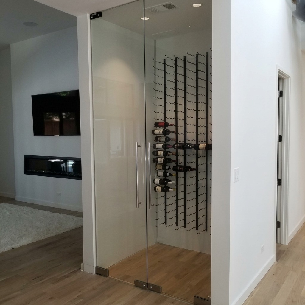 Frameless glass wine room doors with a metal bottle rack