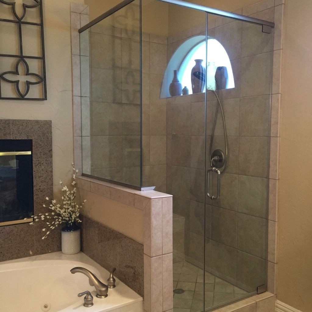 Frameless glass shower on a tiled knee wall beside a garden tub