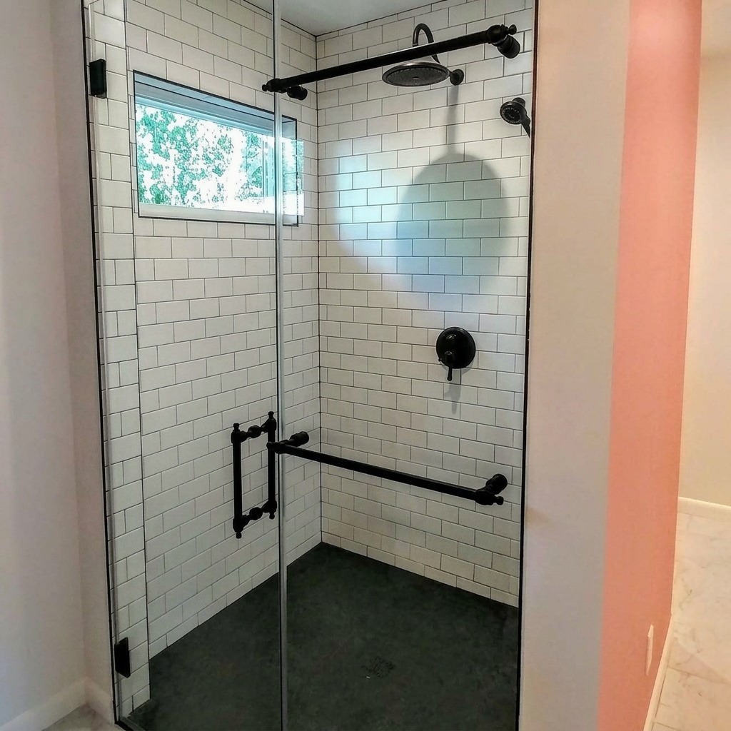 Frameless inline glass shower with matte black hardware and white subway tile