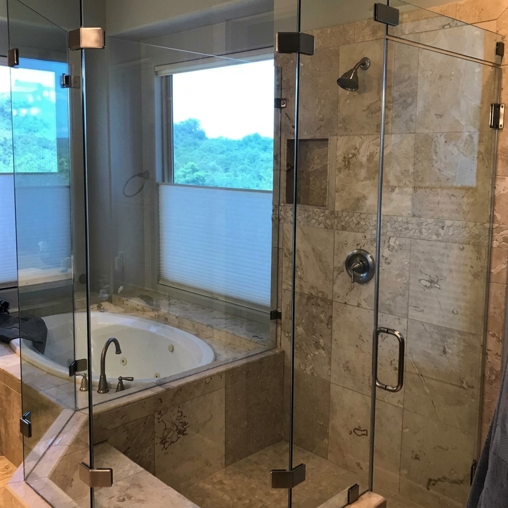 Neo-angle frameless glass shower beside a corner tub deck