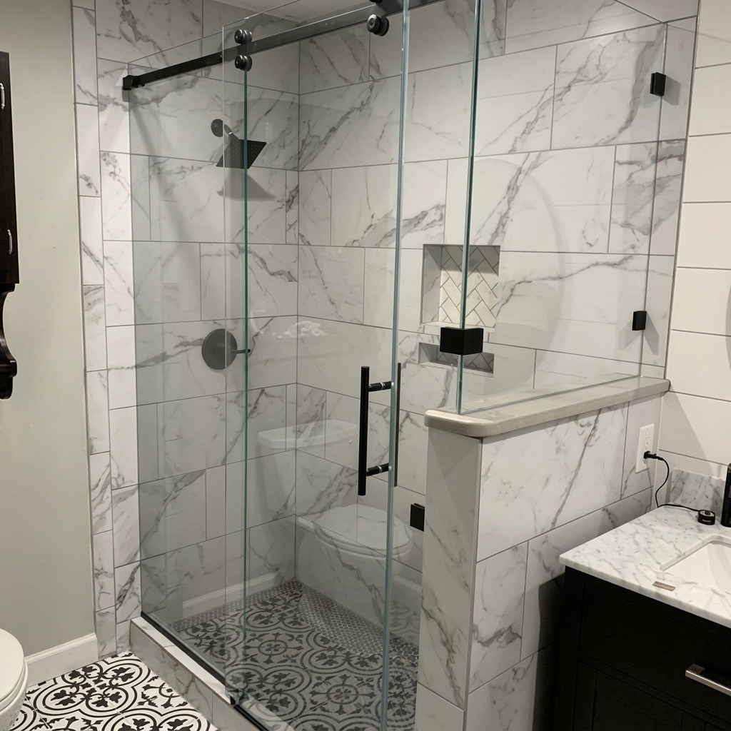 Frameless sliding glass shower door with marble-look tile and a knee wall