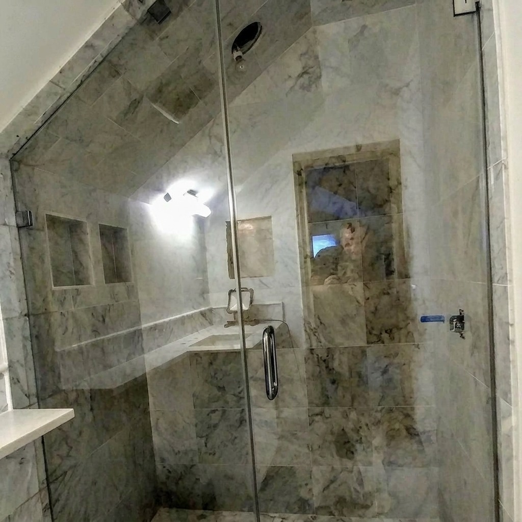 Raked frameless glass steam shower enclosure with marble walls