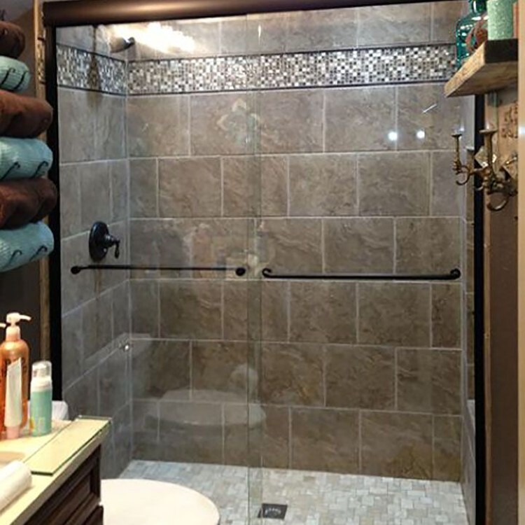 Bypass sliding glass shower doors with a mosaic tile band
