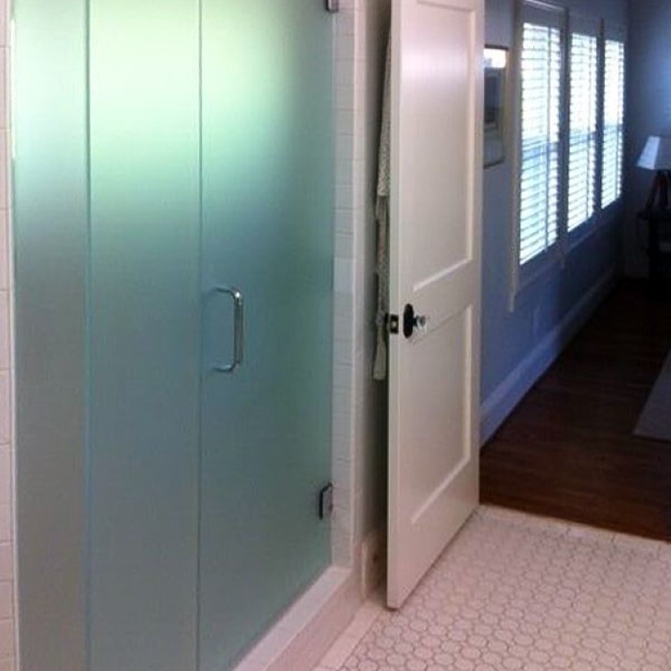 Frameless inline shower doors in full frosted glass