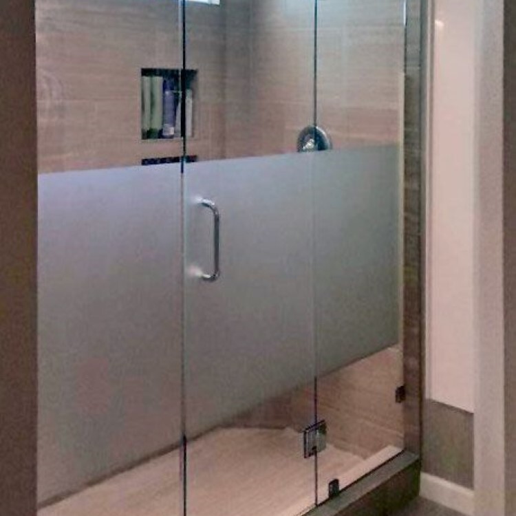 Frameless inline shower door with a frosted privacy band