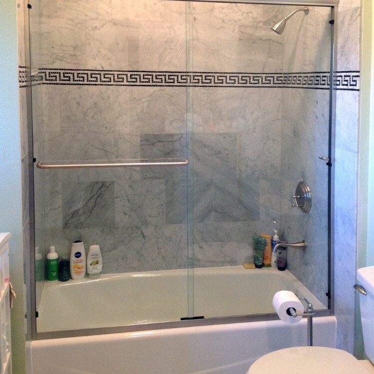 Sliding glass tub doors with a Greek key tile border