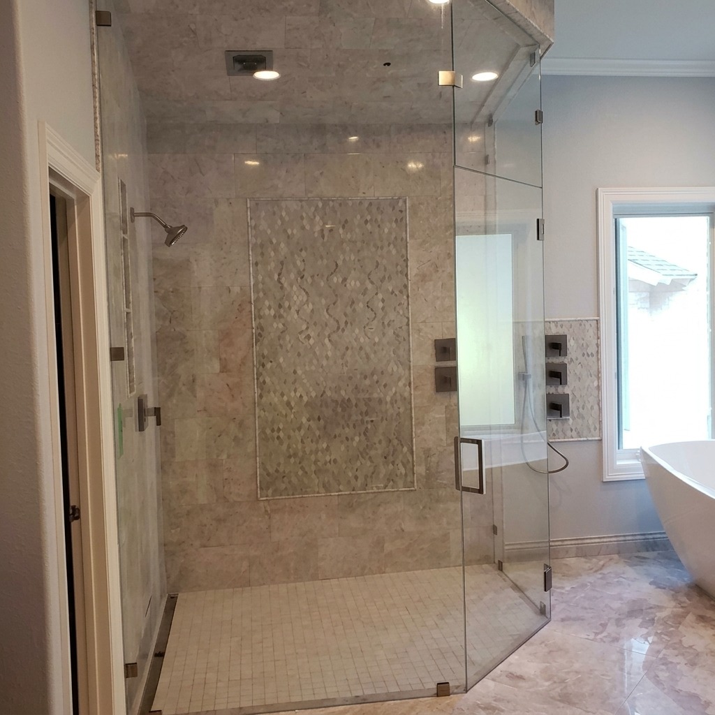 Neo-angle frameless steam shower with transom (high resolution) Neo-angle frameless glass steam shower with a transom and mosaic accent wall