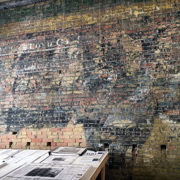 Exposed historic brick wall inside the building