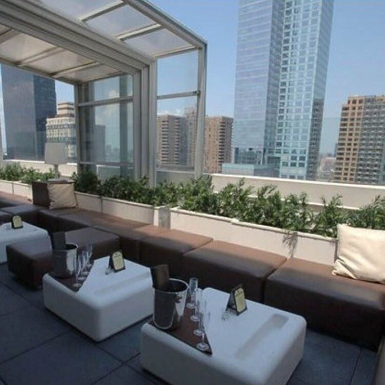 Rendering of a glass-walled rooftop lounge with skyline views