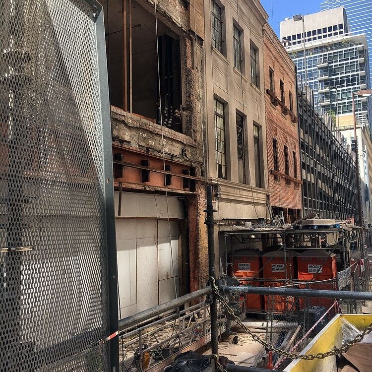 Rear elevation of the historic buildings wrapped in scaffolding