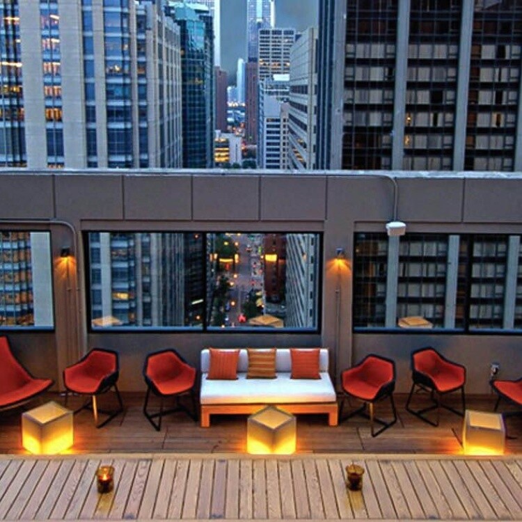 Rendering of a rooftop deck with lounge seating at dusk