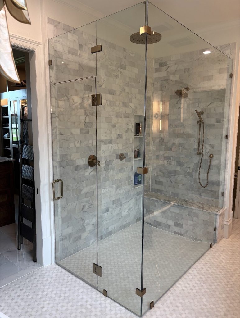 Frameless 90-degree shower enclosure with a glass transom and custom notch in Bartonville, TX