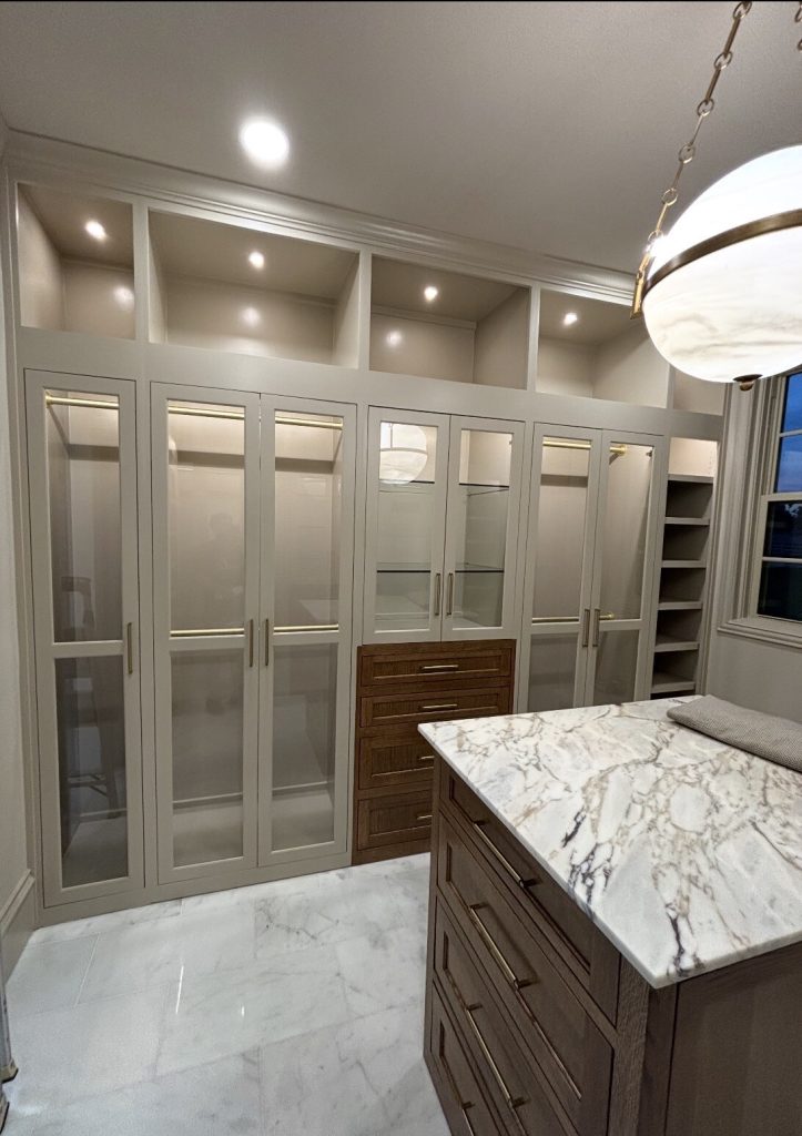 Custom glass cabinet doors in a walk-in closet in Bartonville, TX