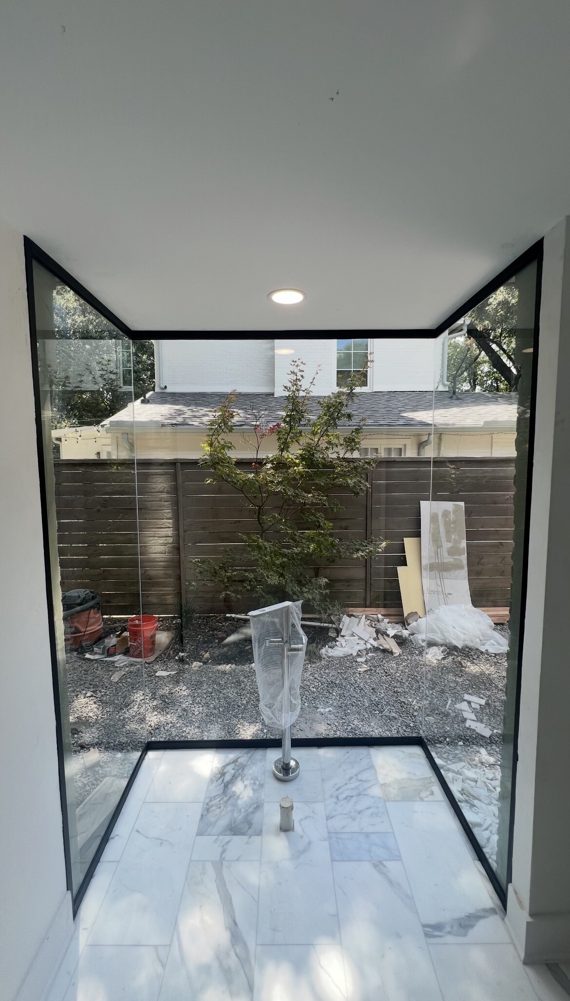 Interior view through the custom commercial glass enclosure with U-channel framing in Dallas, TX