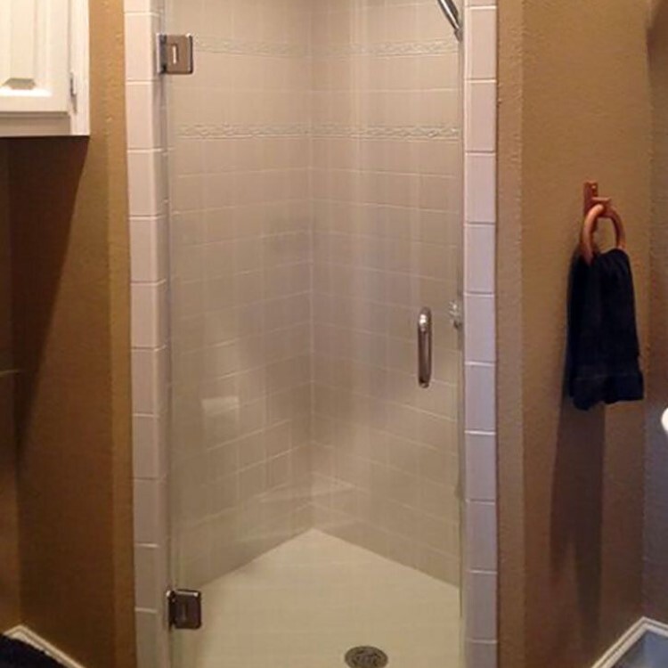 Single frameless glass shower door on a corner shower