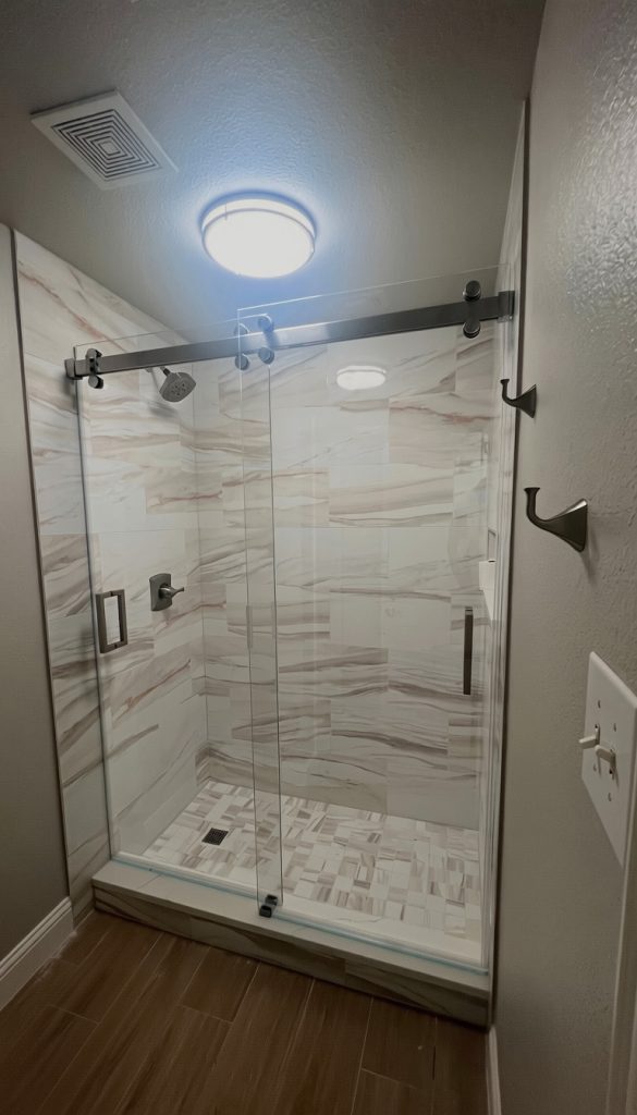 Frameless Cambridge dual sliding shower door with low-iron glass and brushed nickel hardware in Sachse, TX