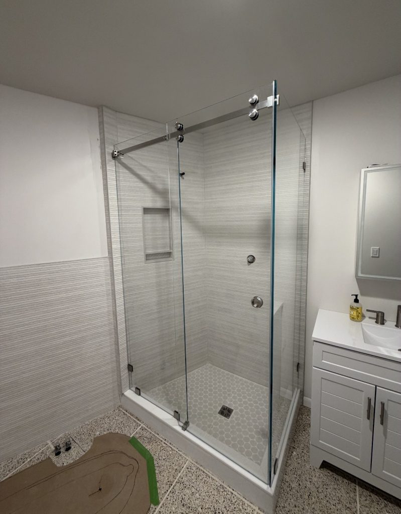 90-degree Serenity sliding shower enclosure with low-iron glass and brushed nickel top rollers in Plano, TX